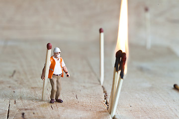 Image showing Miniature people in action with matchsticks