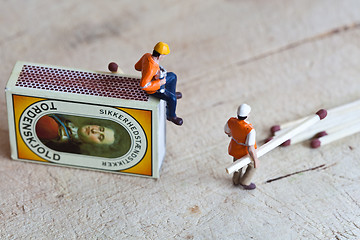 Image showing Miniature people in action with matchsticks