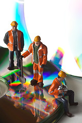 Image showing Miniature people in action with CDs