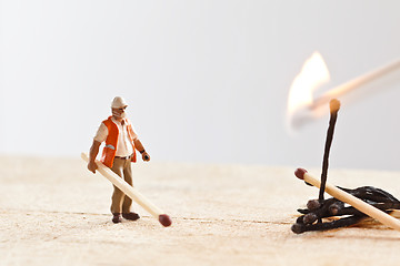 Image showing Miniature people in action with matchsticks