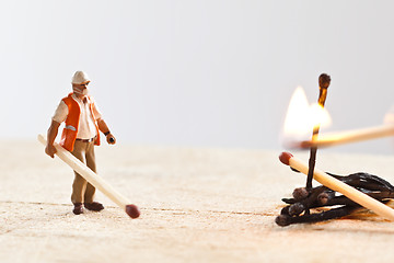 Image showing Miniature people in action with matchsticks