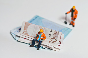 Image showing Miniature people in action with euro banknotes