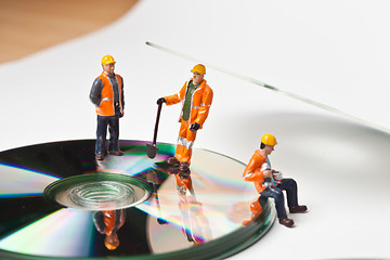 Image showing Miniature people in action with CDs