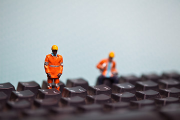 Image showing Miniature people in action on a computer keyboard