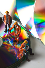 Image showing Miniature people in action with CDs