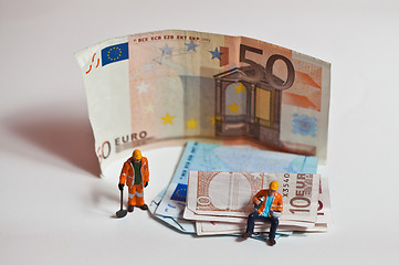 Image showing Miniature people in action with euro banknotes