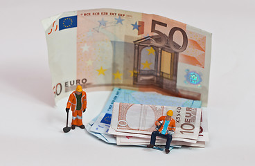 Image showing Miniature people in action with euro banknotes