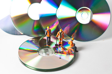 Image showing Miniature people in action with CDs