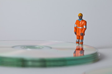 Image showing Miniature people in action with CDs