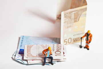 Image showing Miniature people in action with euro banknotes