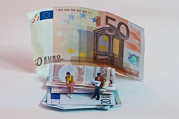 Image showing Miniature people in action with euro banknotes