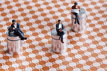 Image showing Miniature people sitting over a roadmap