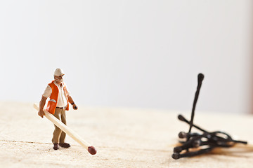 Image showing Miniature people in action with matchsticks