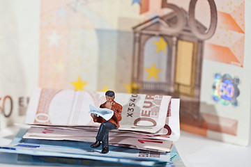 Image showing Miniature people in action with euro banknotes