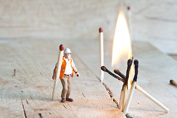 Image showing Miniature people in action with matchsticks