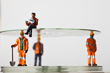 Image showing Miniature people in action with CDs