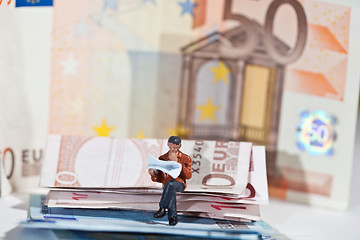 Image showing Miniature people in action with euro banknotes