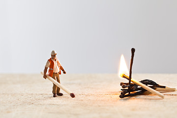 Image showing Miniature people in action with matchsticks