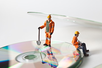 Image showing Miniature people in action with CDs