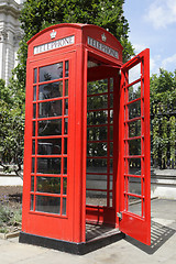 Image showing red telephone box with the door open along cannon street london