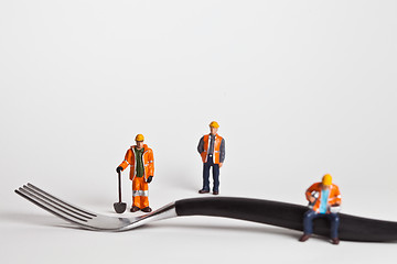 Image showing Miniature people in action worker on a fork