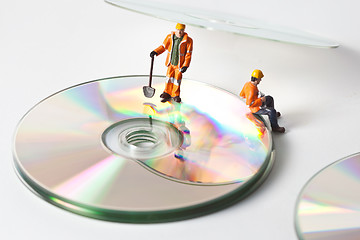 Image showing Miniature people in action with CDs