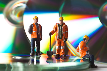 Image showing Miniature people in action with CDs