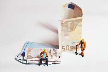 Image showing Miniature people in action with euro banknotes