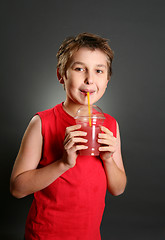 Image showing Child drinking fresh berry juice