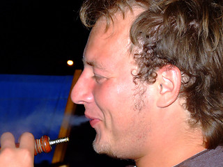 Image showing The guy smokes a hookah and smiles