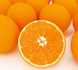 Image showing half oranges and oranges