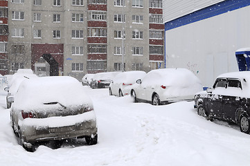 Image showing The cars brought by snow, stand on a road roadside.