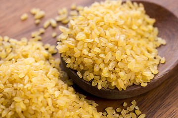 Image showing bulgur wheat in wooden spoon