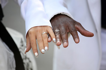 Image showing Causian and African-American couple holding hand with ring