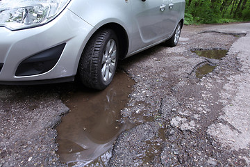 Image showing Damaged road full of cracked potholes in pavement