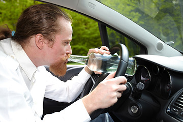 Image showing Drunk man in car with a bottle alcohol