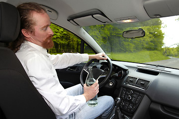 Image showing Drunk man in car with a bottle alcohol