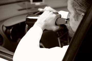 Image showing Drunk man in car with a bottle beer