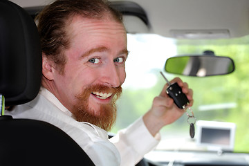 Image showing driver smiling sitting in car and showing new car keys 