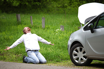 Image showing Driver furious a broken car by the road  