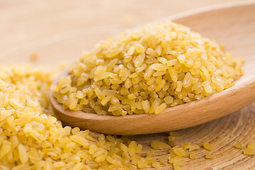 Image showing bulgur wheat in wooden spoon