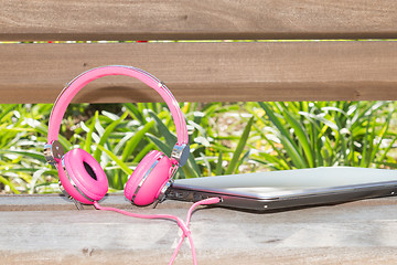 Image showing Vividl pink headphones and laptop
