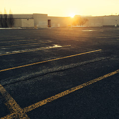 Image showing Empty parking near a shopping mall at sunset