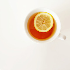 Image showing White cup of tea with lemon