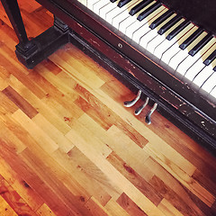 Image showing Vintage piano on old wooden floor
