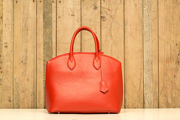 Image showing red purse on wood background