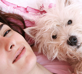 Image showing Dog sleeping on bed 