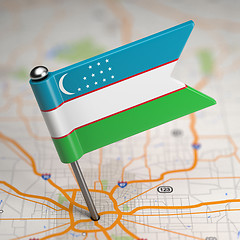 Image showing Uzbekistan Small Flag on a Map Background.
