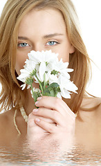 Image showing girl with white chrysanthemum in water