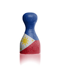 Image showing Wooden pawn with a flag painting